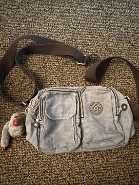Kipling Light Blue Grey Multi-Pocket Crossbody Bag with Monkey Charm